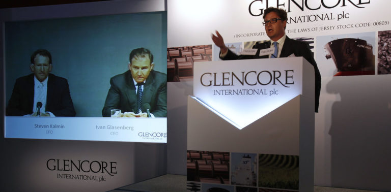 Glencore CEO Ivan Glasenberg and CFO Steven Kalmin are broadcast on a screen during a tele-conference in Hong Kong